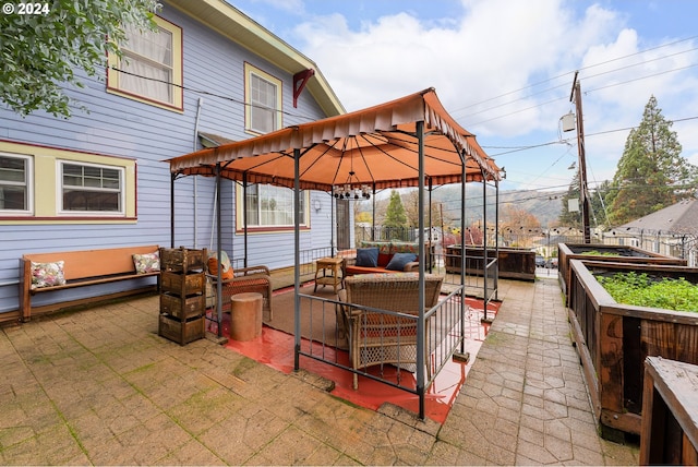 view of patio / terrace featuring a gazebo, outdoor lounge area, and a hot tub