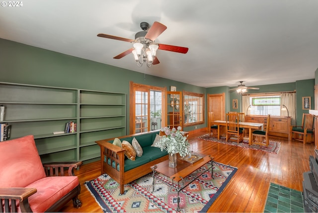 living room featuring wood-type flooring, french doors, and ceiling fan