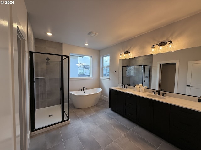 bathroom with plus walk in shower, vanity, and tile patterned floors