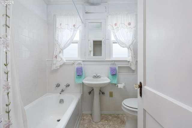 bathroom featuring tile patterned floors, a tub, and toilet