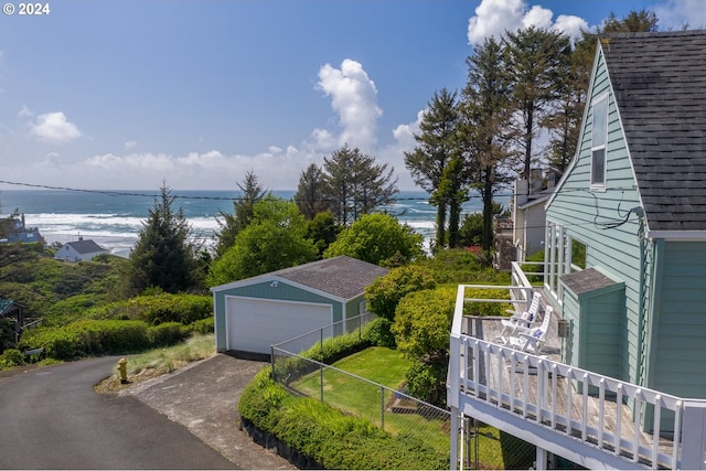 drone / aerial view with a water view and a beach view