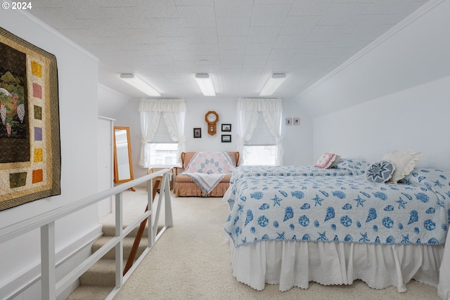 carpeted bedroom featuring lofted ceiling and ornamental molding