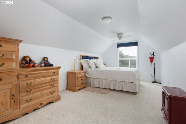 carpeted bedroom with ceiling fan and vaulted ceiling