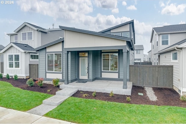 view of front of property with a porch and a front yard