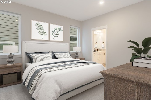 bedroom featuring light carpet and connected bathroom