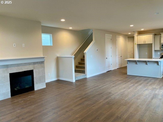 unfurnished living room with a fireplace and dark hardwood / wood-style floors