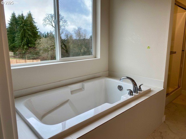 bathroom with a tub to relax in