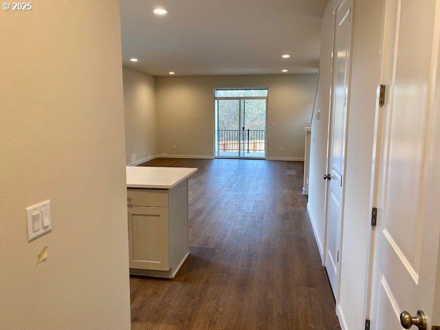 hallway featuring dark hardwood / wood-style flooring