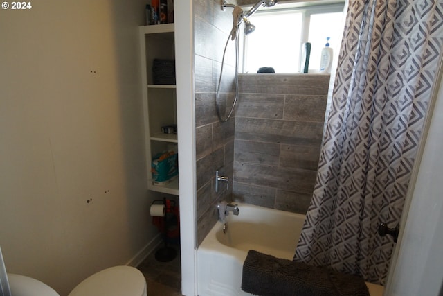 bathroom with toilet and shower / tub combo