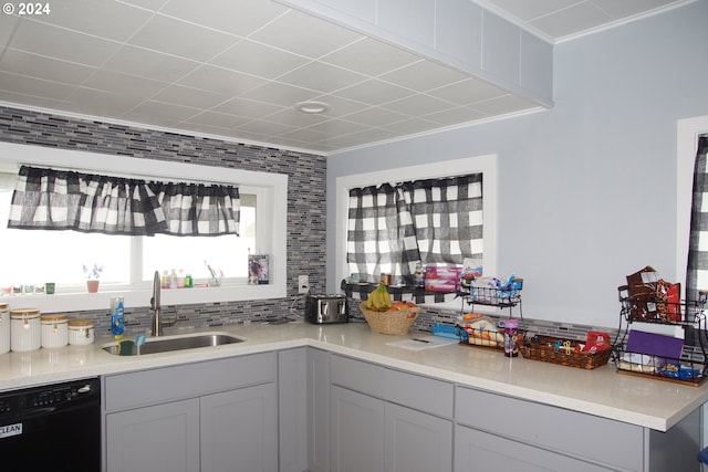 kitchen with gray cabinets, dishwasher, sink, and backsplash