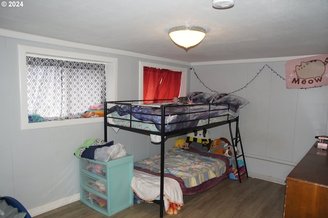 bedroom with dark hardwood / wood-style floors