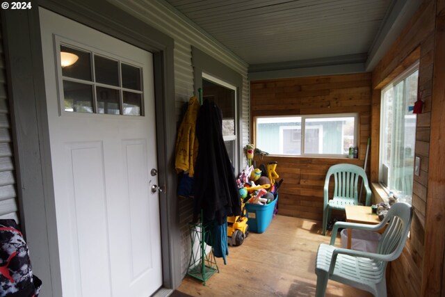 rear view of property with a storage shed and a yard