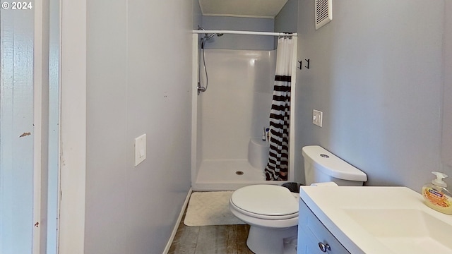 bathroom featuring vanity, hardwood / wood-style floors, a shower with curtain, and toilet