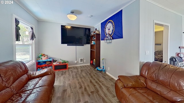 living room with ornamental molding and wood-type flooring