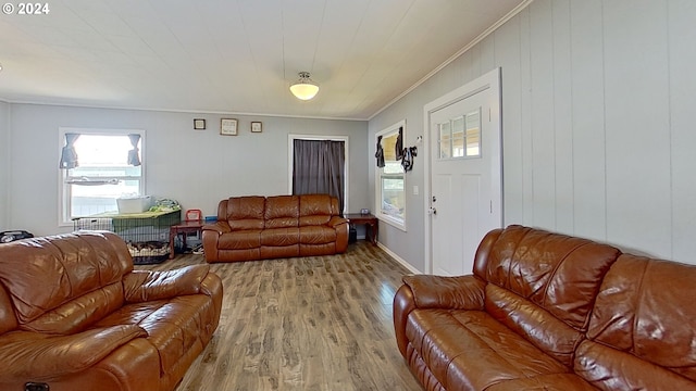 living room with crown molding and light hardwood / wood-style floors