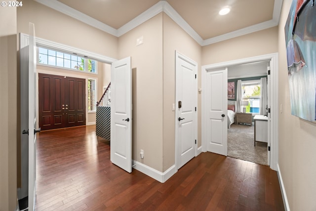 entryway featuring dark hardwood / wood-style floors and crown molding