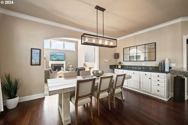 dining area featuring crown molding and dark hardwood / wood-style flooring