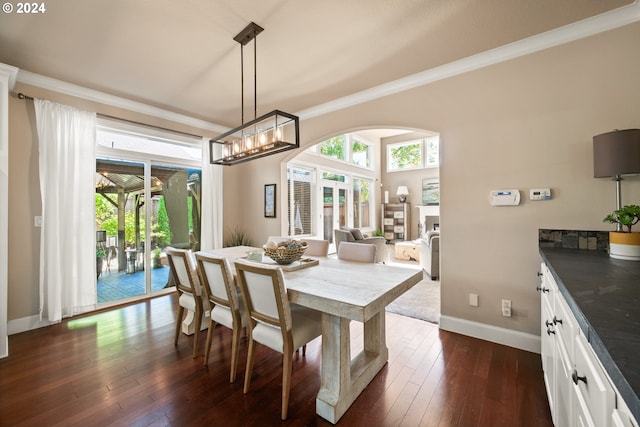 dining space with dark hardwood / wood-style floors and crown molding