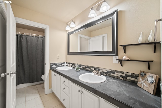 bathroom featuring vanity, toilet, curtained shower, tile patterned flooring, and decorative backsplash