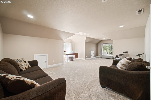 living room featuring light colored carpet, a textured ceiling, and vaulted ceiling