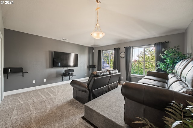 living room featuring lofted ceiling and carpet flooring