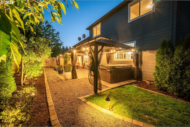 view of yard featuring a gazebo, a patio, and a hot tub