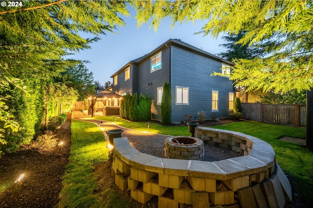 exterior space featuring a lawn and an outdoor fire pit