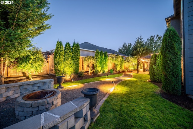 view of yard with a fire pit