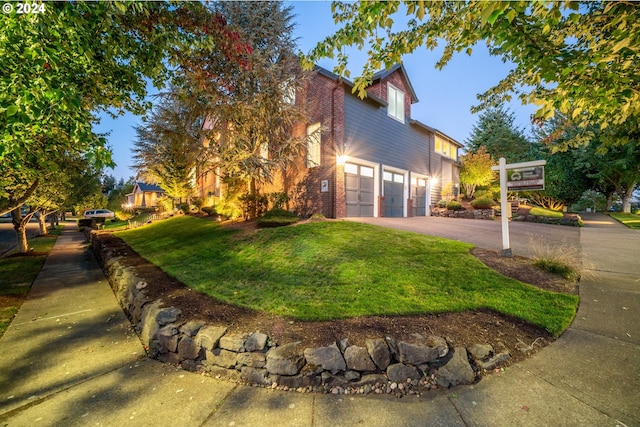 view of home's exterior with a garage and a lawn