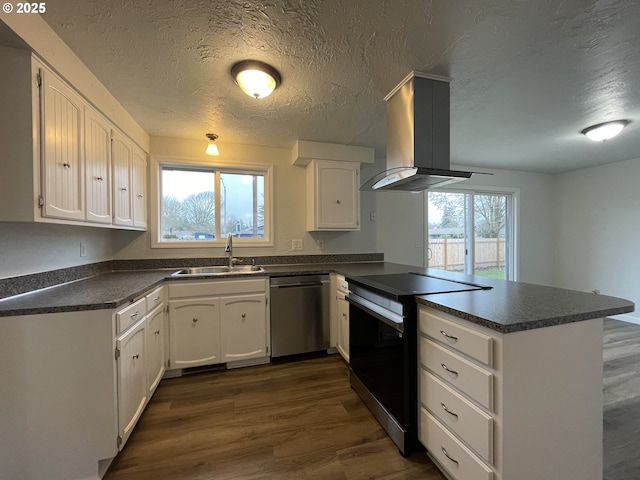 kitchen with white cabinetry, island range hood, and kitchen peninsula