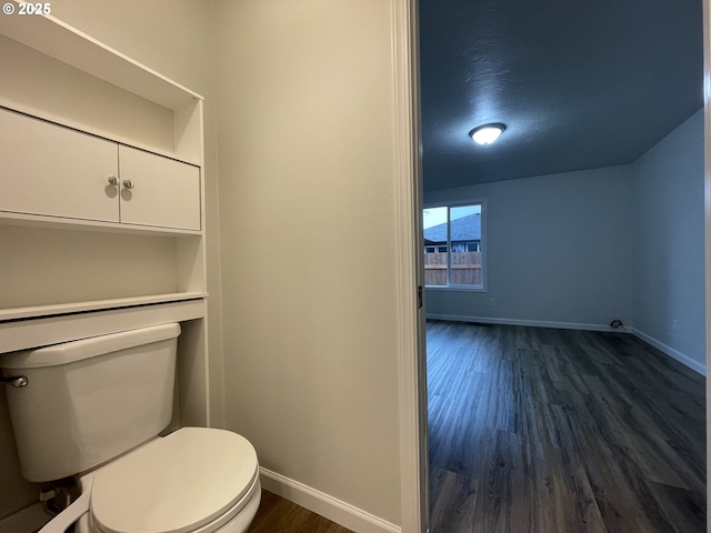 bathroom with toilet and wood-type flooring