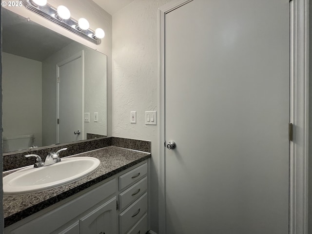 bathroom featuring toilet and vanity