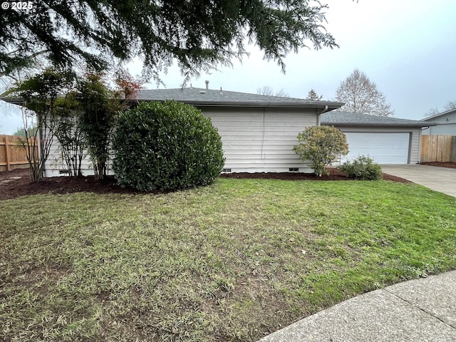 view of home's exterior with a garage and a yard