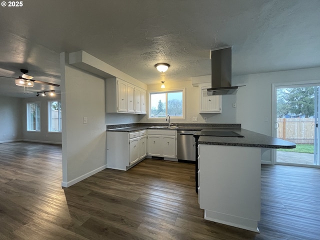 kitchen featuring dishwasher, kitchen peninsula, sink, white cabinets, and island range hood