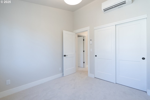 unfurnished bedroom featuring light colored carpet, a wall mounted air conditioner, and a closet