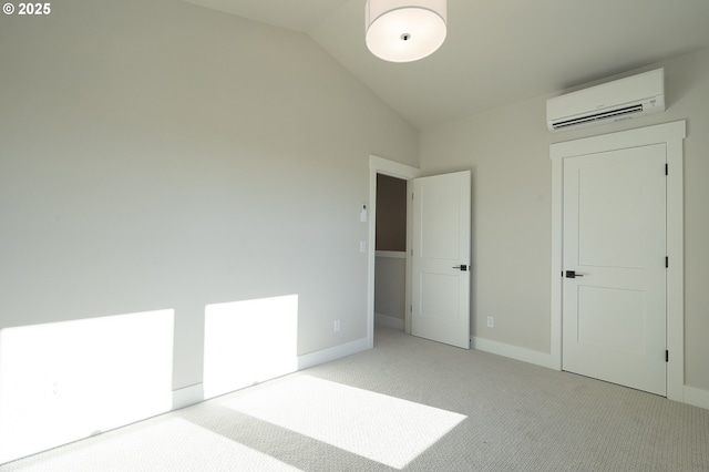 unfurnished bedroom with light carpet, a wall mounted AC, and lofted ceiling