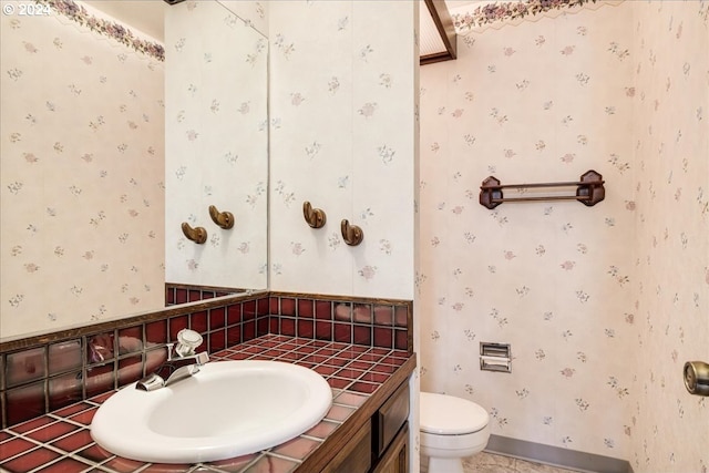 bathroom with tile patterned flooring, vanity, and toilet