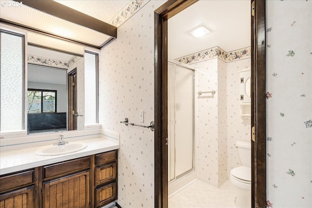 bathroom with vanity, toilet, and walk in shower