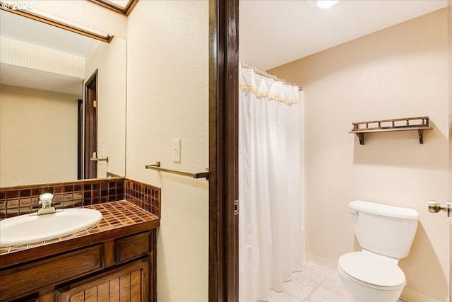 bathroom with vanity, tasteful backsplash, and toilet