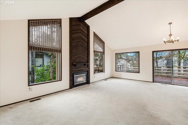 unfurnished living room featuring carpet, beamed ceiling, a chandelier, and a healthy amount of sunlight