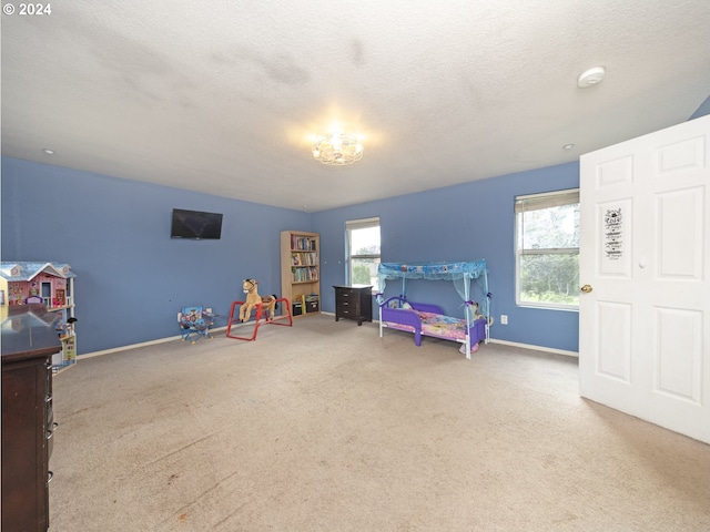 carpeted bedroom featuring a textured ceiling