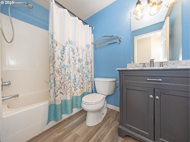 full bathroom with vanity, hardwood / wood-style floors, toilet, and shower / bath combo with shower curtain