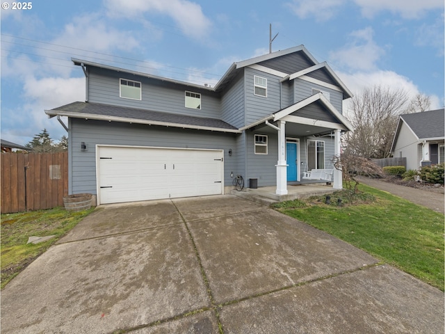 view of front facade with a garage, a front yard, and covered porch