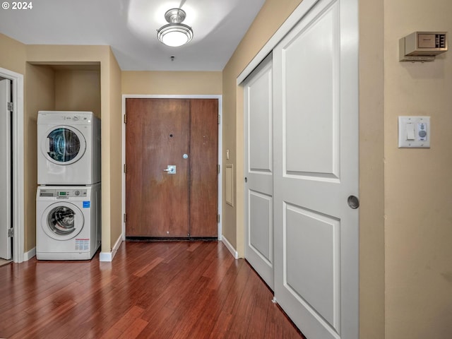 entrance foyer featuring dark hardwood / wood-style floors and stacked washer / drying machine