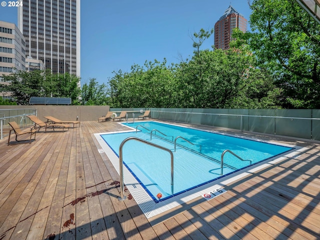 view of swimming pool featuring a wooden deck