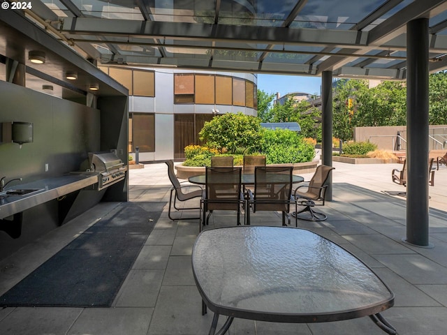 view of patio with a grill, a pergola, and an outdoor kitchen