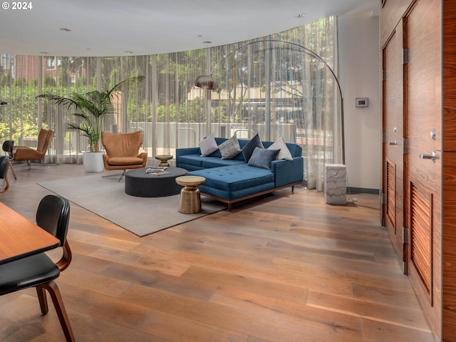 living room featuring floor to ceiling windows and hardwood / wood-style flooring