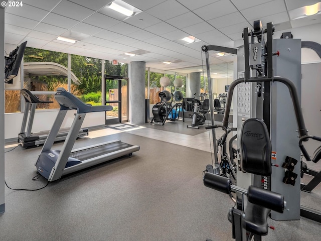 gym with a paneled ceiling