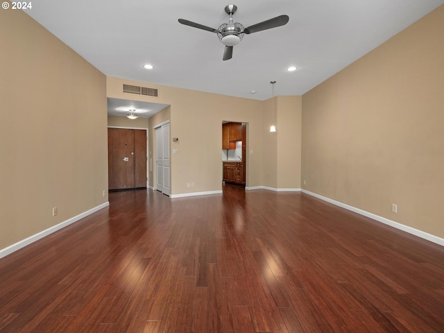 unfurnished room featuring ceiling fan and dark hardwood / wood-style flooring