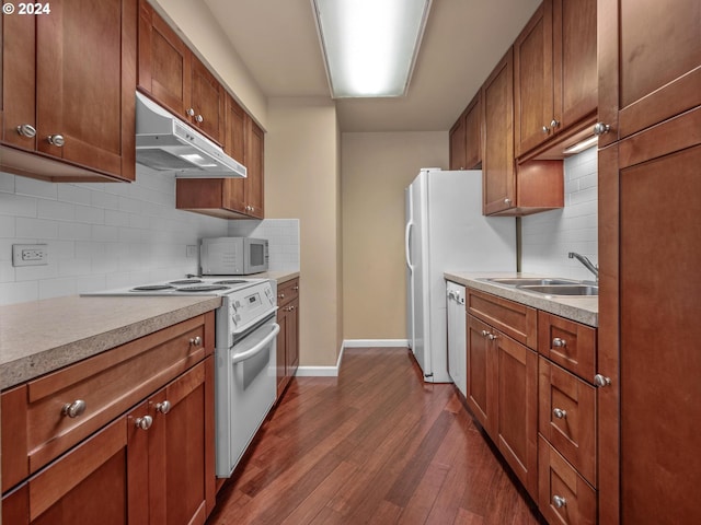 kitchen featuring backsplash, sink, white appliances, and dark hardwood / wood-style flooring